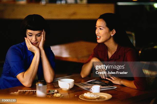 women talking in a cafe - women talking stock pictures, royalty-free photos & images