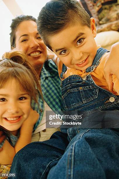 boy and girl sitting with mother, all smiling - all stock pictures, royalty-free photos & images