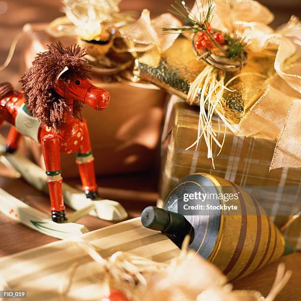 spinning top, miniature rocking horse and wrapped gifts - miniature horse stock pictures, royalty-free photos & images