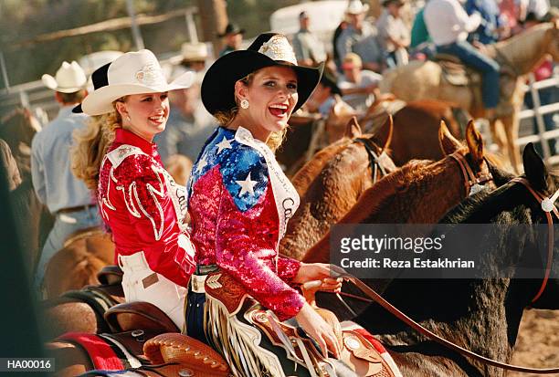 rodeo queens riding in pageant, smiling - cowgirl stock-fotos und bilder
