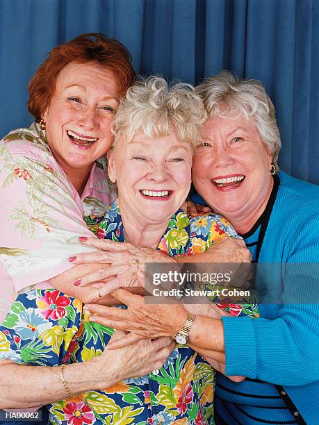 three mature women in photo booth embracing and laughing - stewart stock pictures, royalty-free photos & images