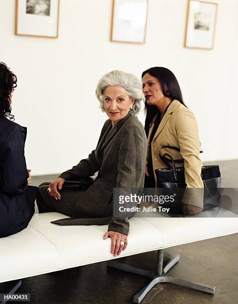 three generations of women in art gallery, mature woman in middle - friends museum fotografías e imágenes de stock