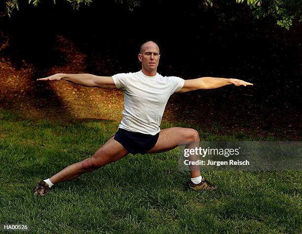 man doing stretching exercises on lawn - jurgen stock pictures, royalty-free photos & images
