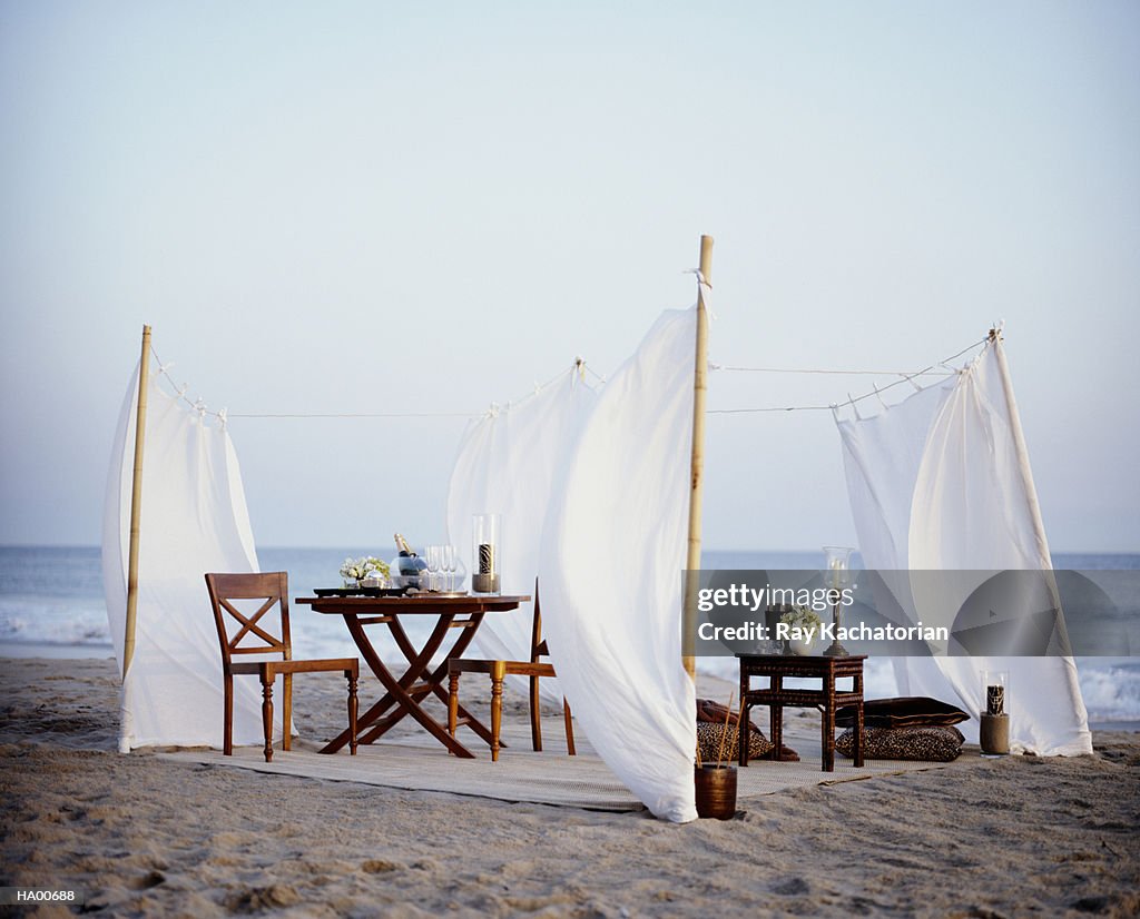 Tables and chairs on beach,  champagne in bowl with ice