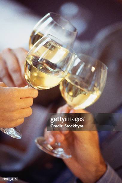 hands holding wine glasses, making toast - glass half full party stock pictures, royalty-free photos & images