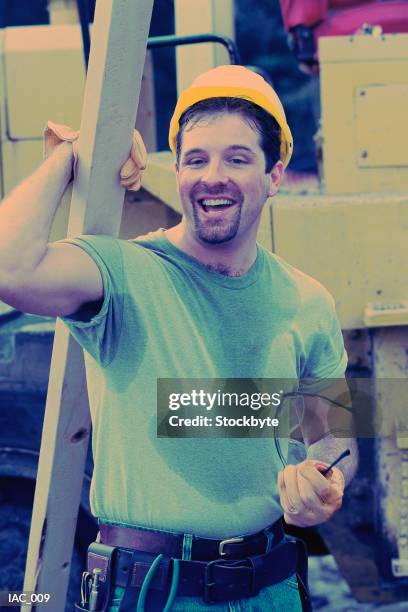 man holding lumber and smiling, sweating - sweat stains stock pictures, royalty-free photos & images