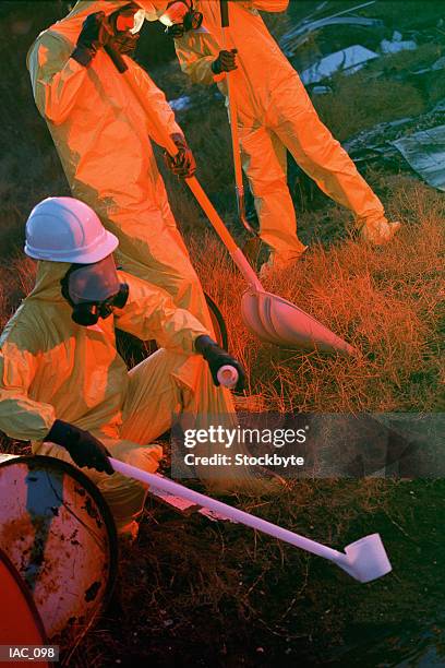 people in protective clothing taking toxic sample - geiger fotografías e imágenes de stock