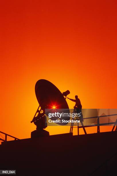 silhouette of person and satellite dish - satellite dish stock-fotos und bilder