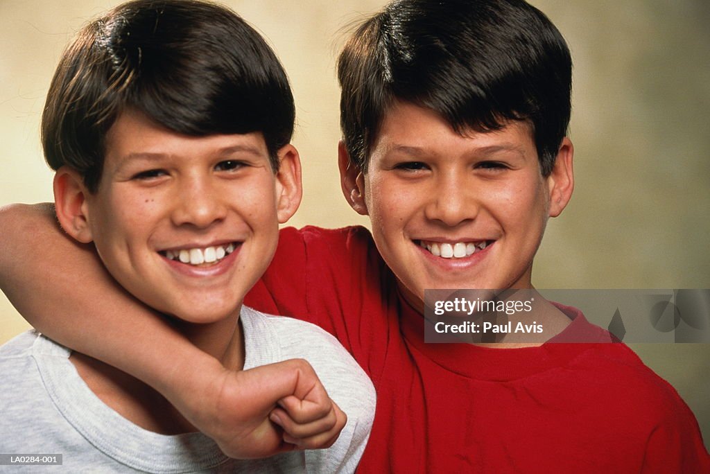 Male twins (10-12) smiling, portrait
