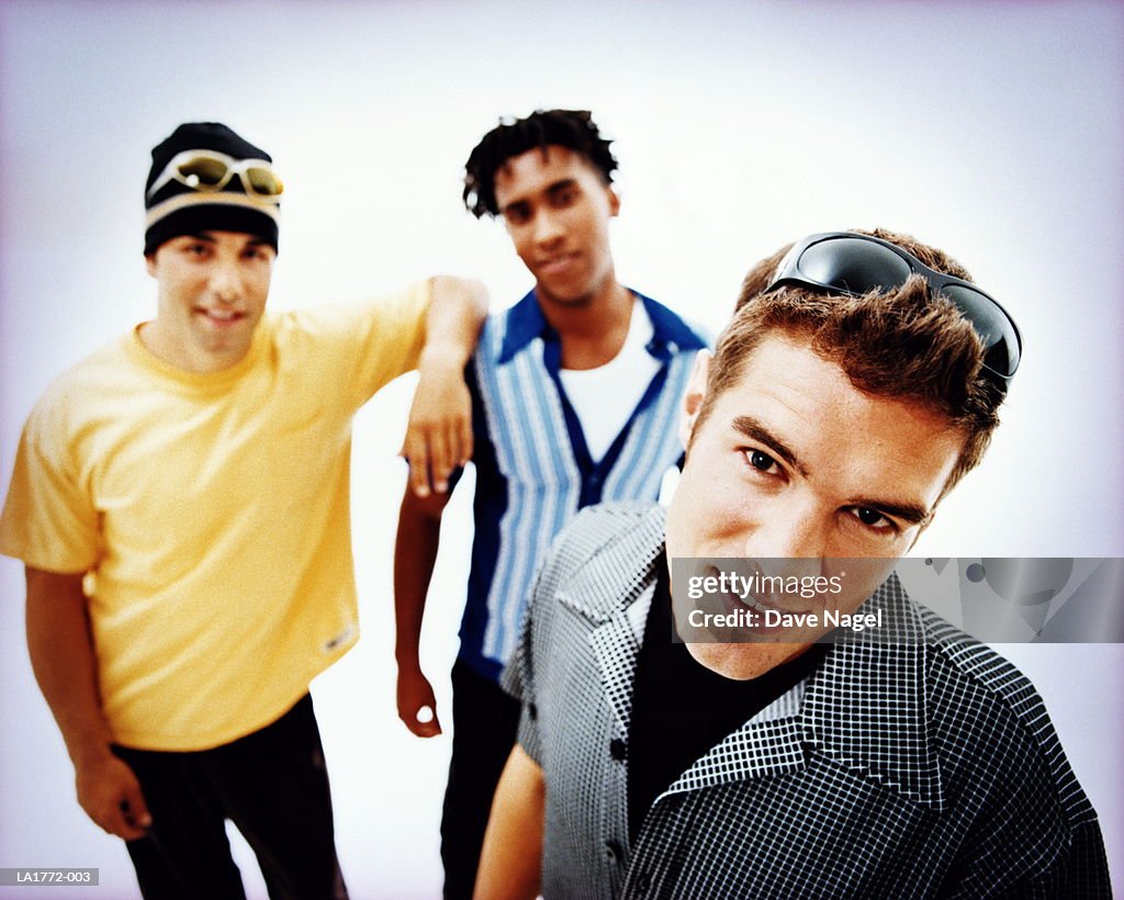 Three teenage boys (17-19) smiling, portrait