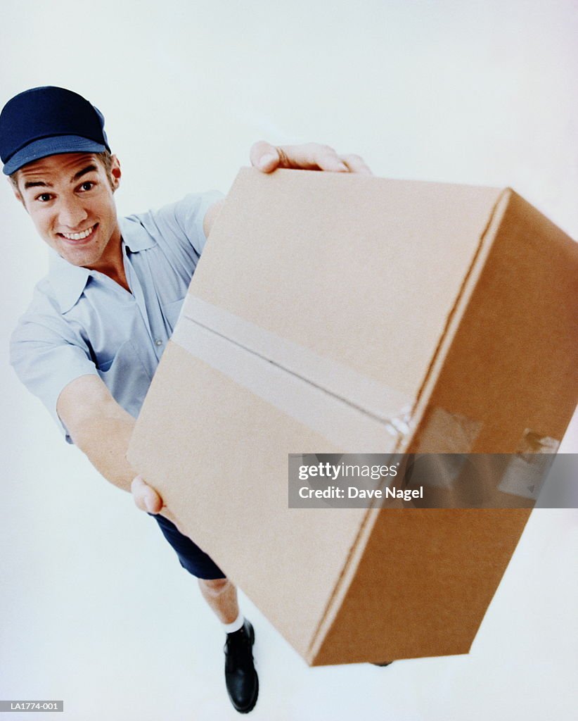 Teenage boy (17-19) delivering package, elevated view