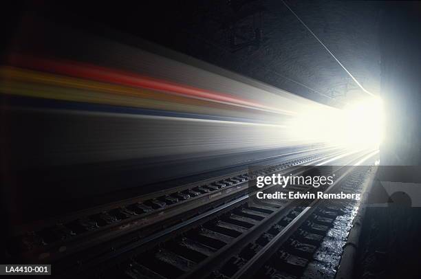 train speeding through tunnel, usa (long exposure) - dark tunnel stock pictures, royalty-free photos & images