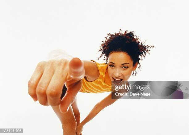 young woman bending over, pointing finger, portrait (wide angle) - wide angle lens stock pictures, royalty-free photos & images