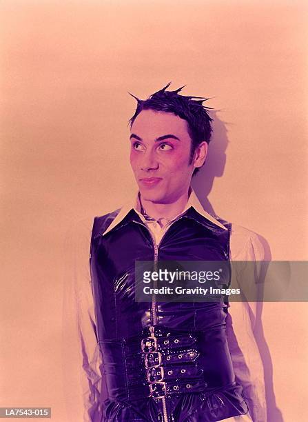 young man wearing pvc waistcoat, smiling, close-up, portrait - spiked stock pictures, royalty-free photos & images
