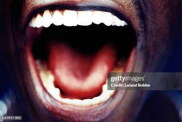 man's open mouth, close-up - boca abierta fotografías e imágenes de stock