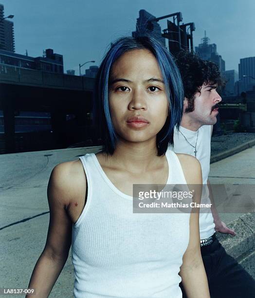 young woman, portrait, man in background - portrait close up woman 20 29 stock pictures, royalty-free photos & images