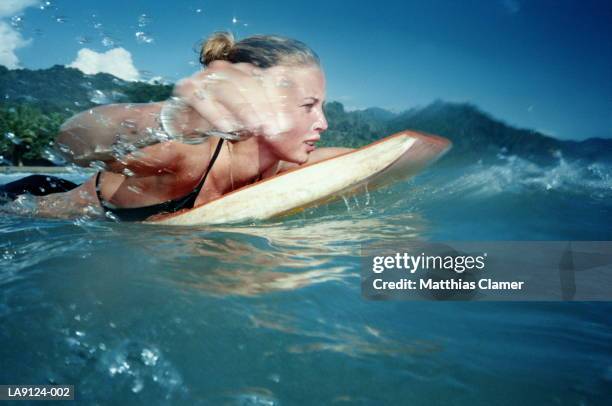 woman in water on bodyboard - bodyboard fotografías e imágenes de stock