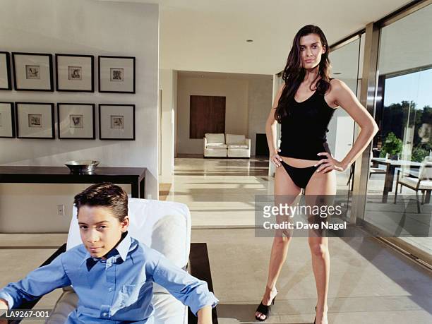 boy (8-10) and young woman in living room, portrait - kids in undies stock pictures, royalty-free photos & images