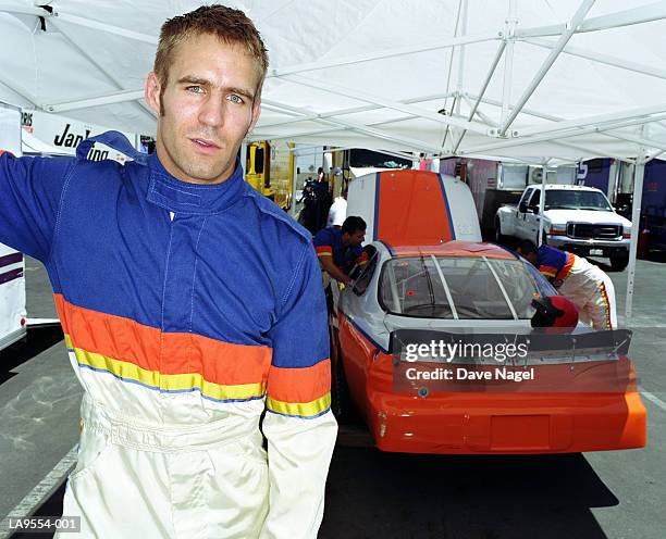 racing car driver in garage, portrait - mechanic portrait stockfoto's en -beelden