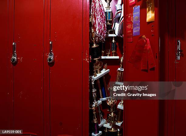 trophies stacked in open locker - trophy display stock pictures, royalty-free photos & images