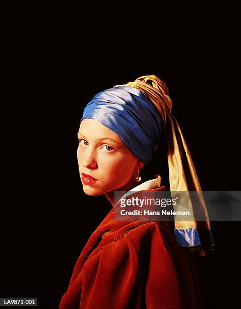 young woman posing as 'girl with a pearl earring' by jan vermeer - look alike ストックフォトと画像
