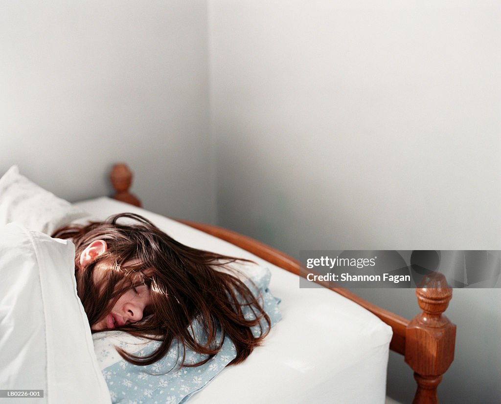 Young woman sleeping in bed