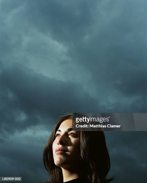 businesswoman standing under stormy sky, close-up, portrait - ominous stock pictures, royalty-free photos & images