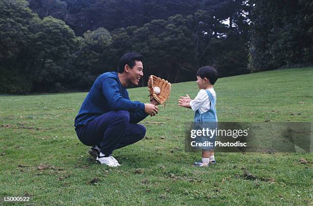 father and son playing catch - playing catch stock pictures, royalty-free photos & images