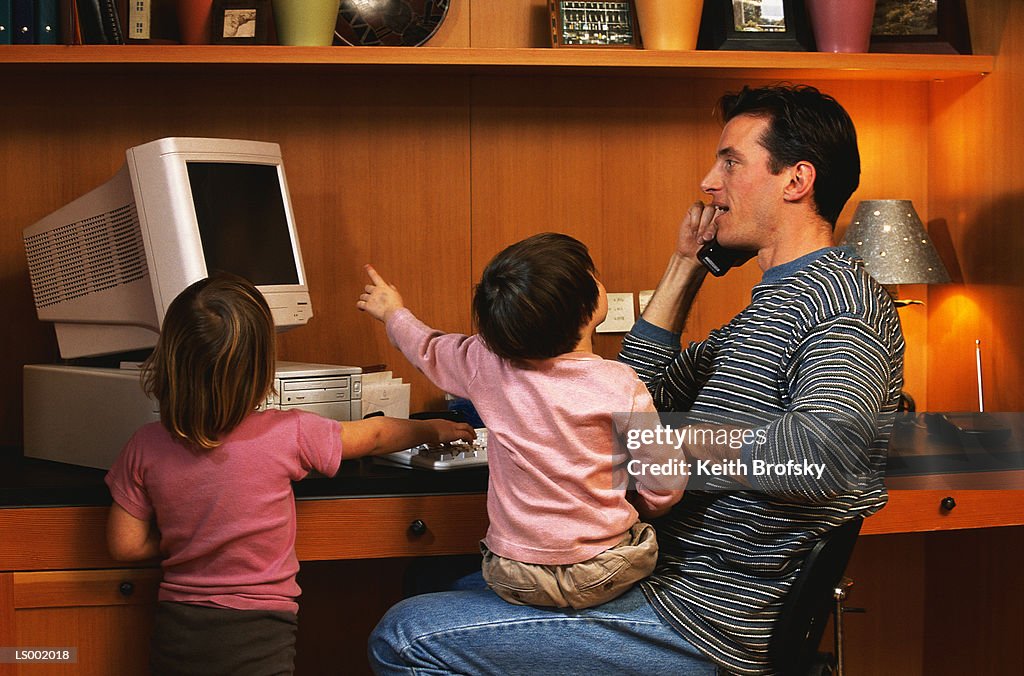 Father and His Children in Their Home Office