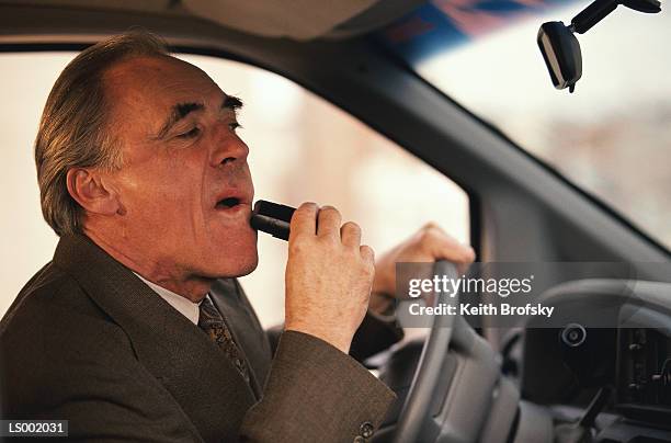 businessman shaving and driving a car - shaver transportation company stock pictures, royalty-free photos & images