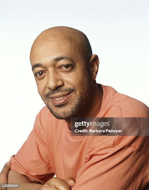 smiling man with arms folded - black shirt folded stock pictures, royalty-free photos & images