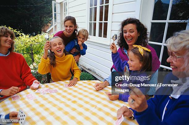 family at card table playing spoons - card table stock pictures, royalty-free photos & images