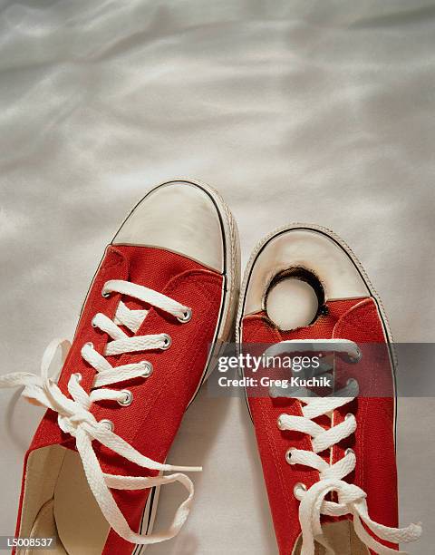 tennis shoes with hole in the toe - greg stock pictures, royalty-free photos & images
