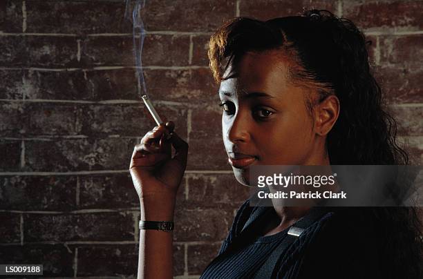 woman smoking - patrick wall stock pictures, royalty-free photos & images