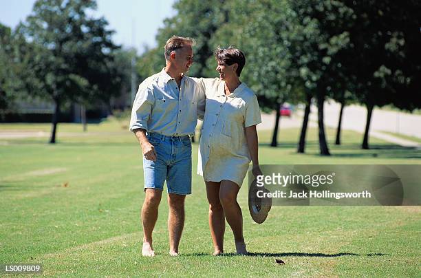 couple walking in park - maternity wear stock pictures, royalty-free photos & images