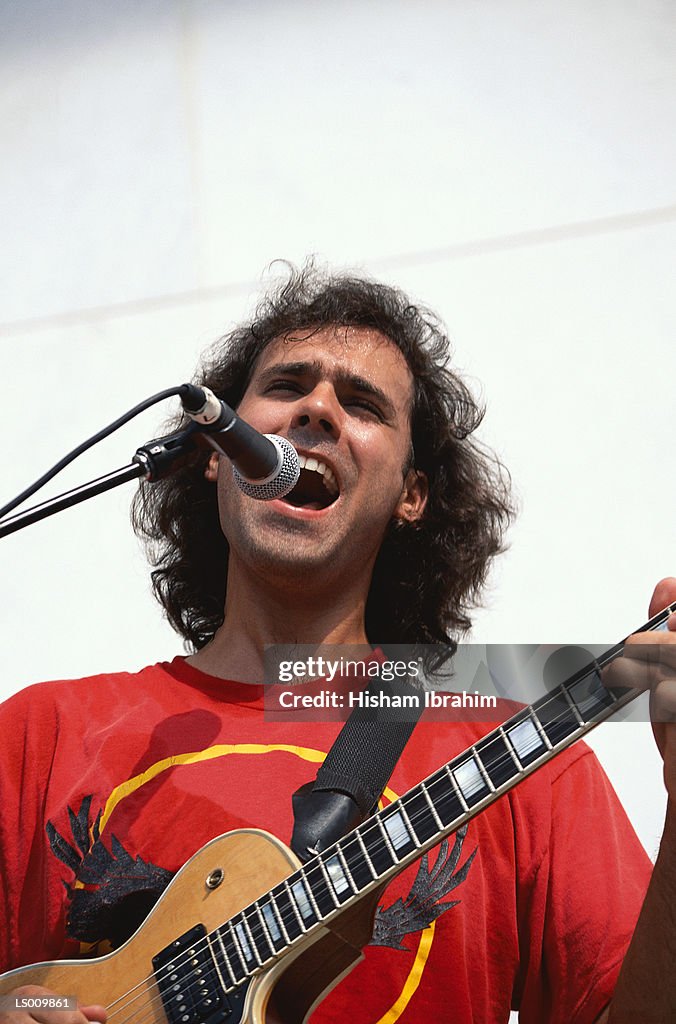 Man Singing and Playing Guitar