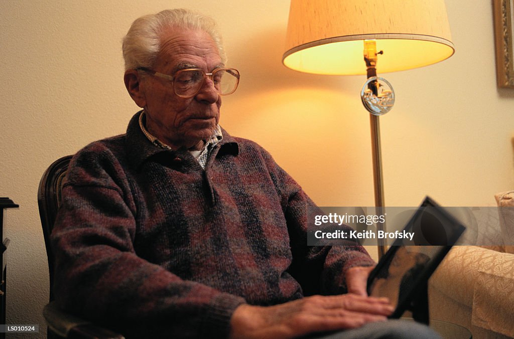 Man Looking at Picture