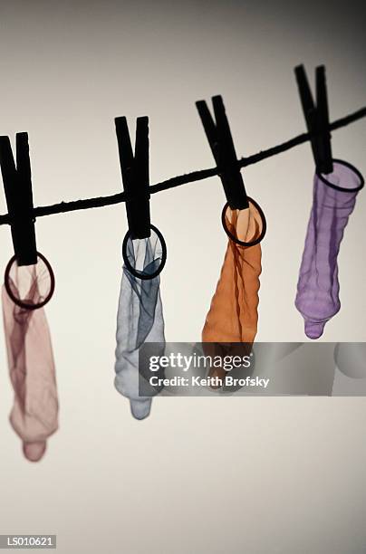 hanging condoms - phallus shaped stock pictures, royalty-free photos & images