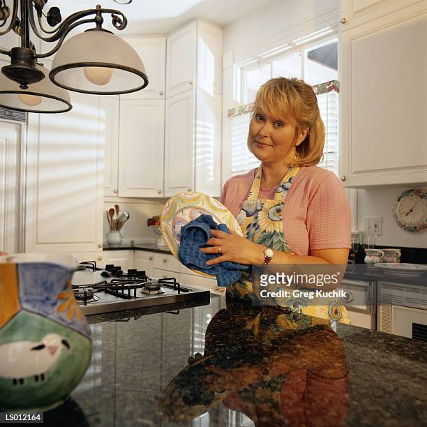 woman in suburban kitchen - greg stock pictures, royalty-free photos & images