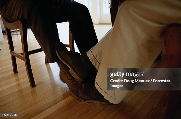 playing footsies - playing footsie stock pictures, royalty-free photos & images