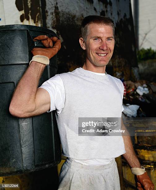 carrying garbage can - schrottpresse stock-fotos und bilder