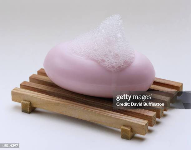 bar of soap on a wodden dish - soap dish stock pictures, royalty-free photos & images