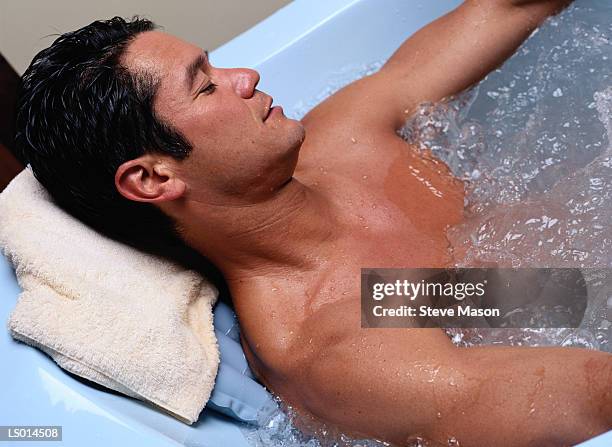 man in hot tub - balneotherapy stock pictures, royalty-free photos & images