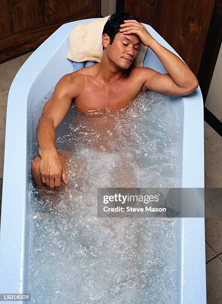 man in a hot tub - balneotherapy stock pictures, royalty-free photos & images