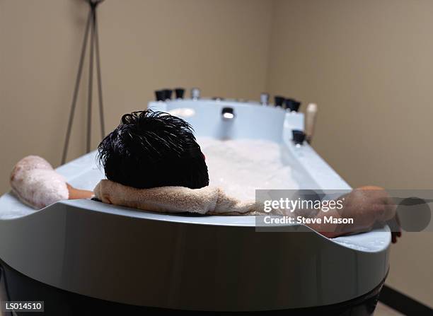 man in hot tub - balneotherapy stock pictures, royalty-free photos & images