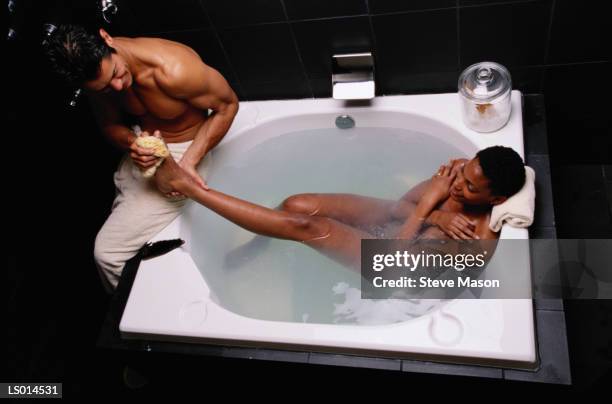 couple in hot tub - balneotherapy stock pictures, royalty-free photos & images