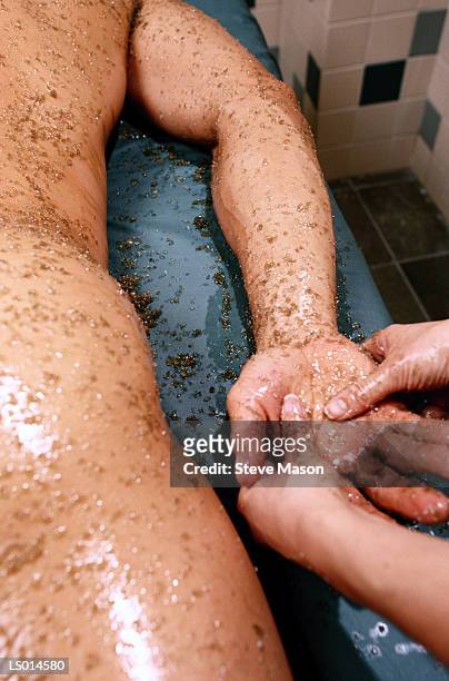 man getting sea salt scrub - hand massage stock pictures, royalty-free photos & images