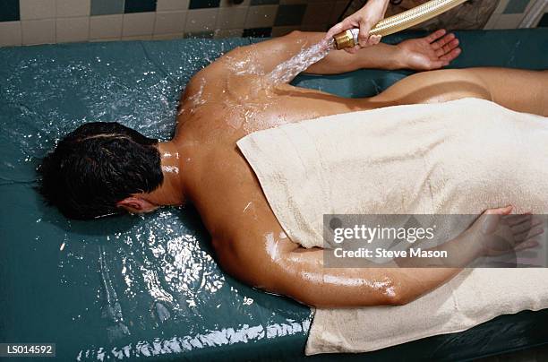 man being hosed off - backstube stock pictures, royalty-free photos & images