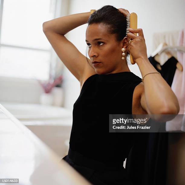 woman brushing hair - brushing hair stock pictures, royalty-free photos & images