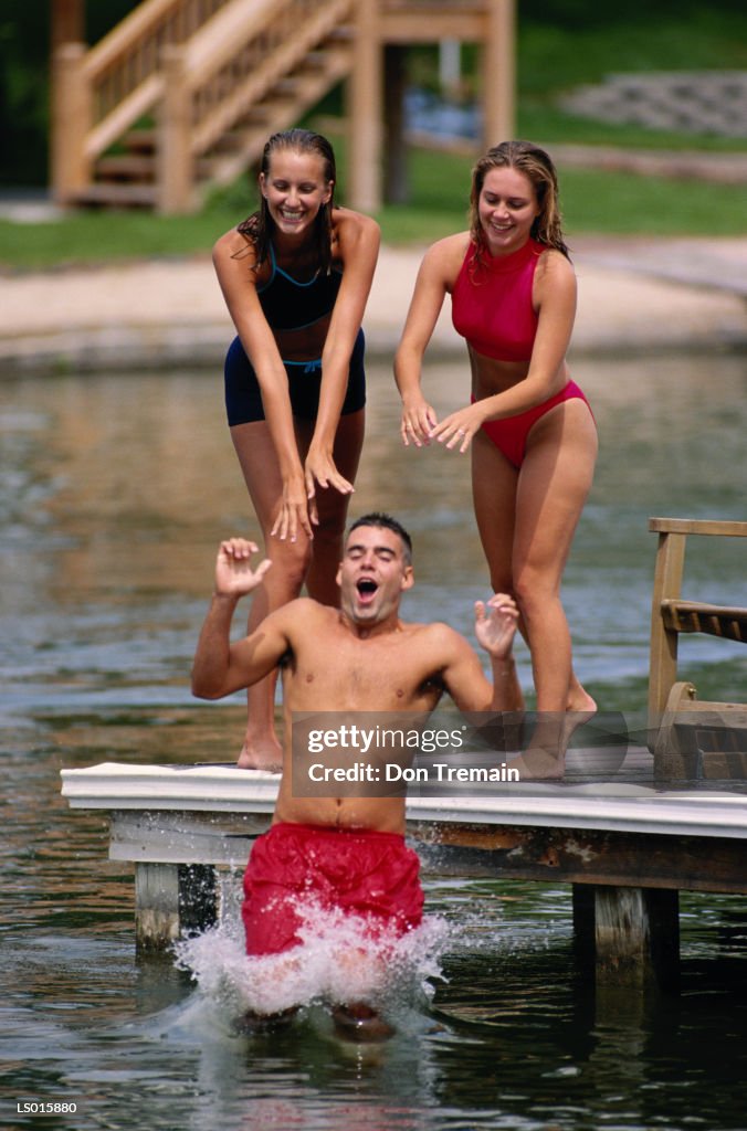 Girls Dunking Boy off Swimming Dock